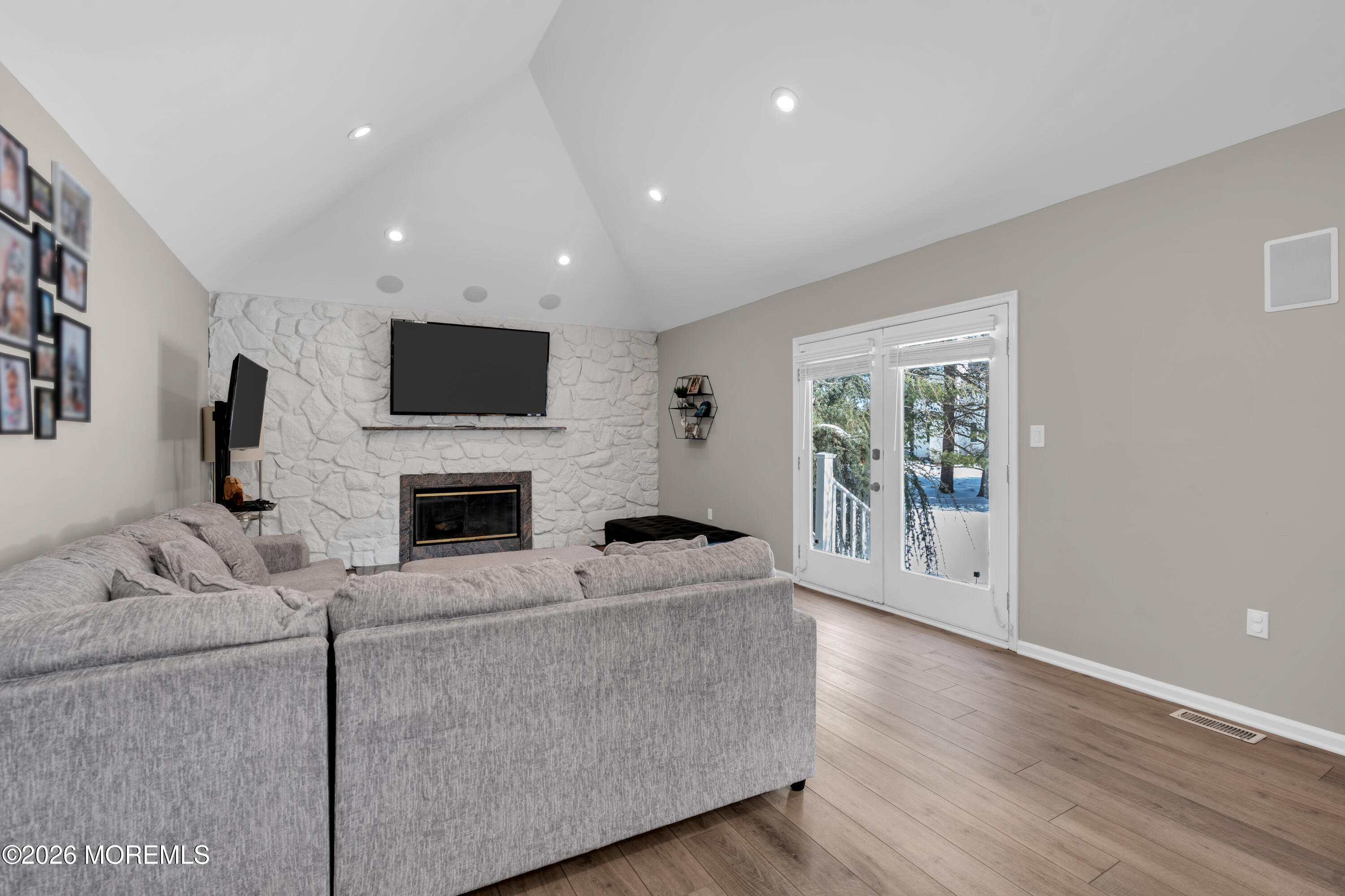 15 Lenape Trail Freehold, NJ 07728 - Photo 24 of 27 a living room with furniture a fireplace and a flat screen tv