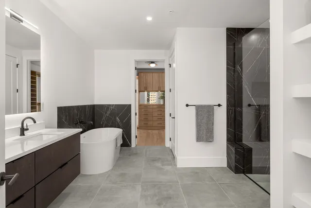 a bathroom with a sink toilet shower and a mirror