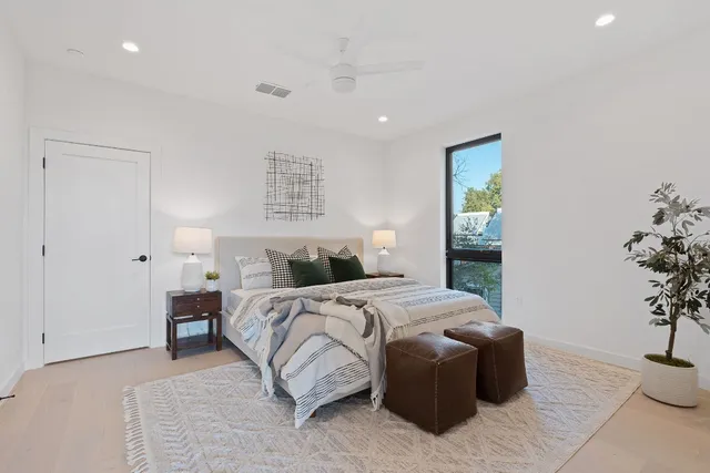 a bedroom with a bed and a potted plant