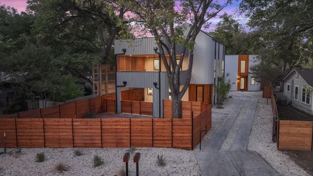 a front view of a house with a tree