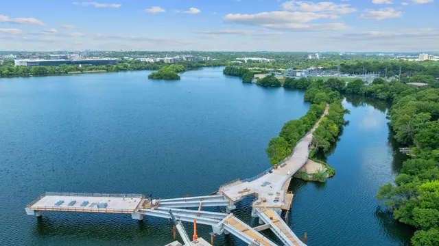 an aerial view of a house with garden space and lake view