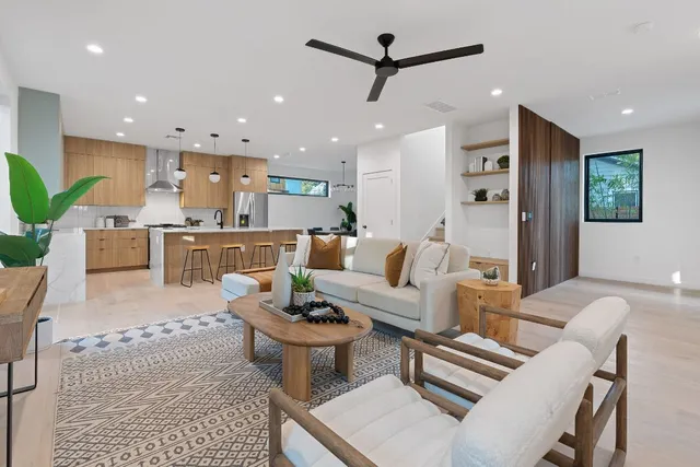 a living room with furniture and a view of kitchen