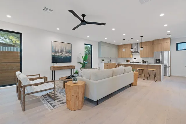 a living room with furniture and a kitchen view