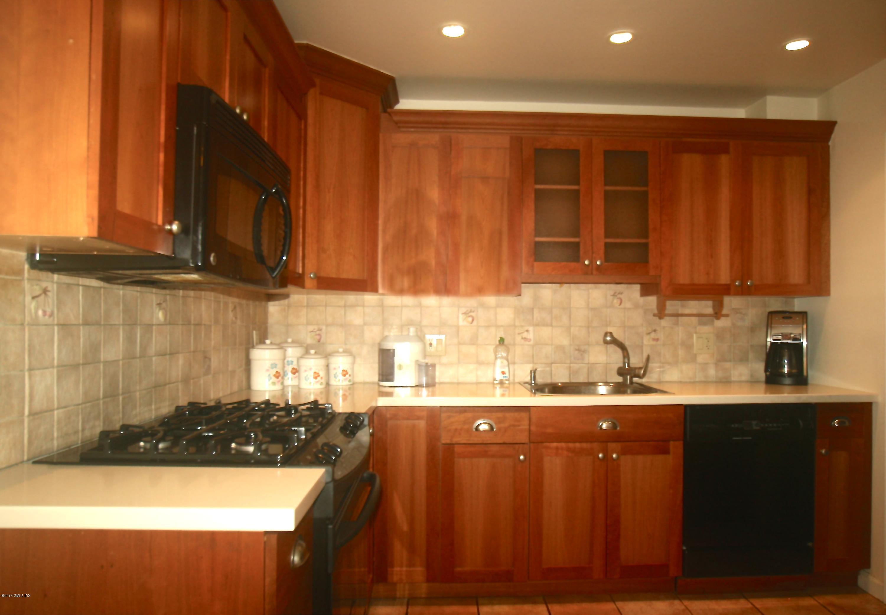 37 Sheep Hill Road, Unit 13 Riverside, CT 06878 - Photo 3 of 11 a kitchen with a sink and cabinets