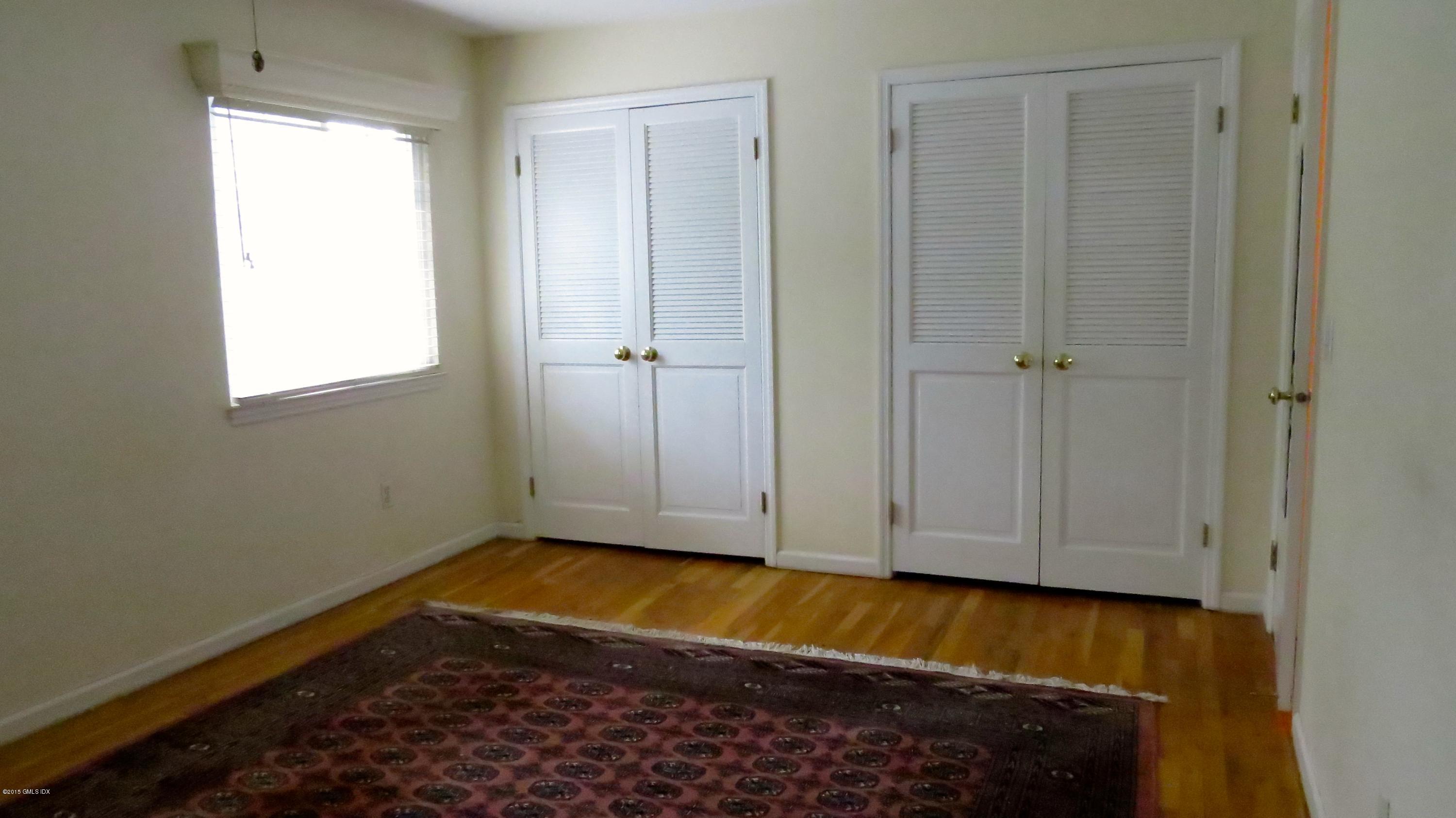 37 Sheep Hill Road, Unit 13 Riverside, CT 06878 - Photo 6 of 11 a view of empty room with wooden floor and fan