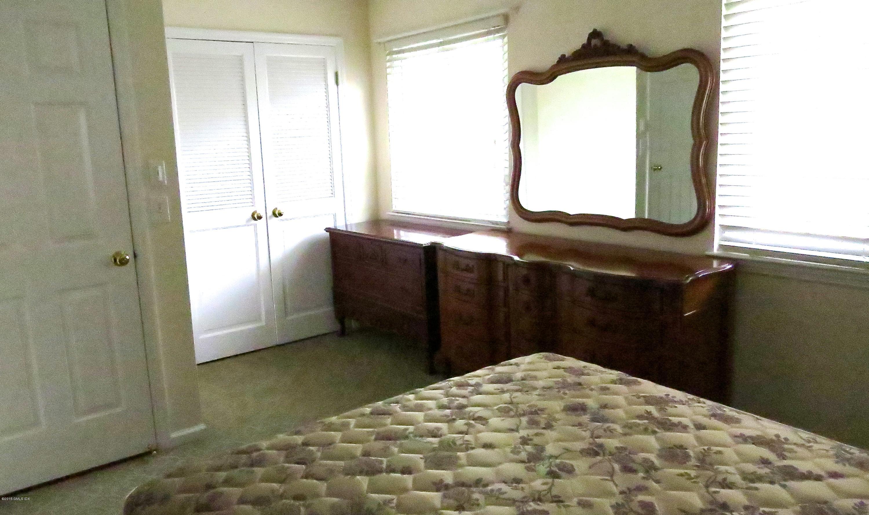 37 Sheep Hill Road, Unit 13 Riverside, CT 06878 - Photo 7 of 11 a bedroom with a bed and a mirror