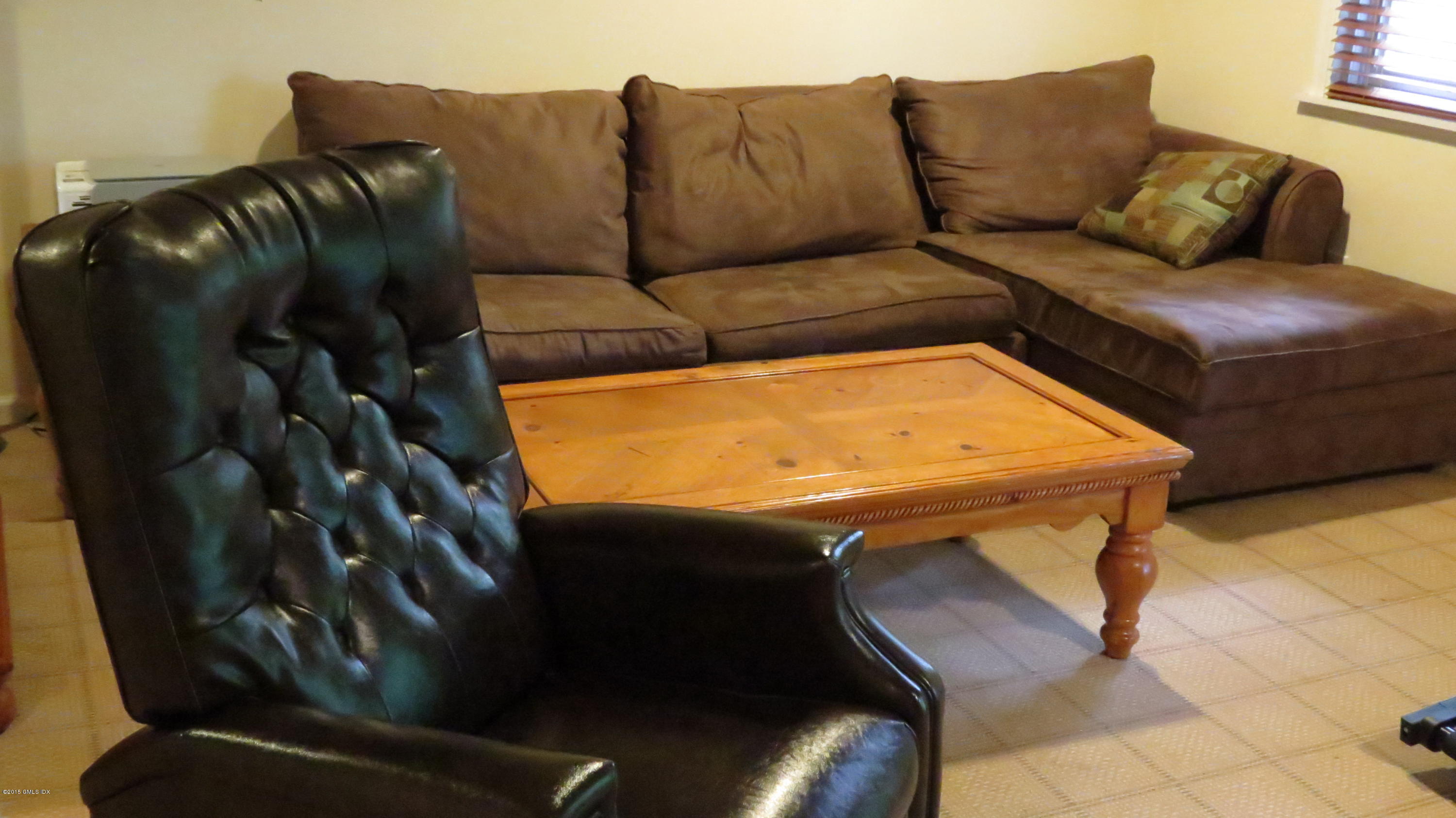 37 Sheep Hill Road, Unit 13 Riverside, CT 06878 - Photo 10 of 11 a living room with a couch
