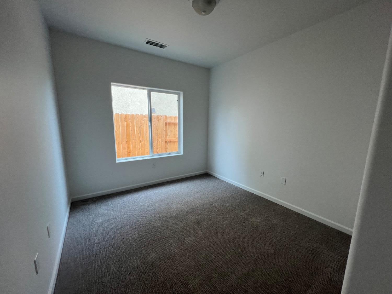 1502 Concord Way Dinuba, CA 93618 - Photo 11 of 12 an empty room with a window