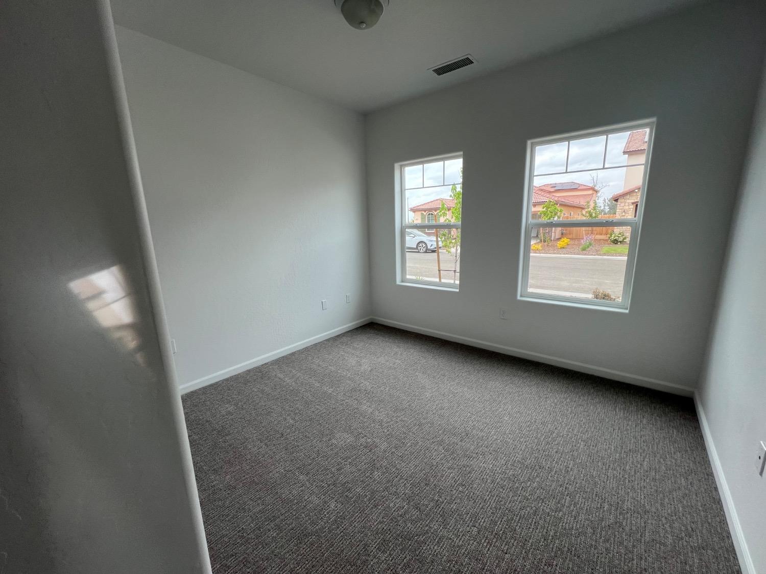 1502 Concord Way Dinuba, CA 93618 - Photo 12 of 12 an empty room with windows