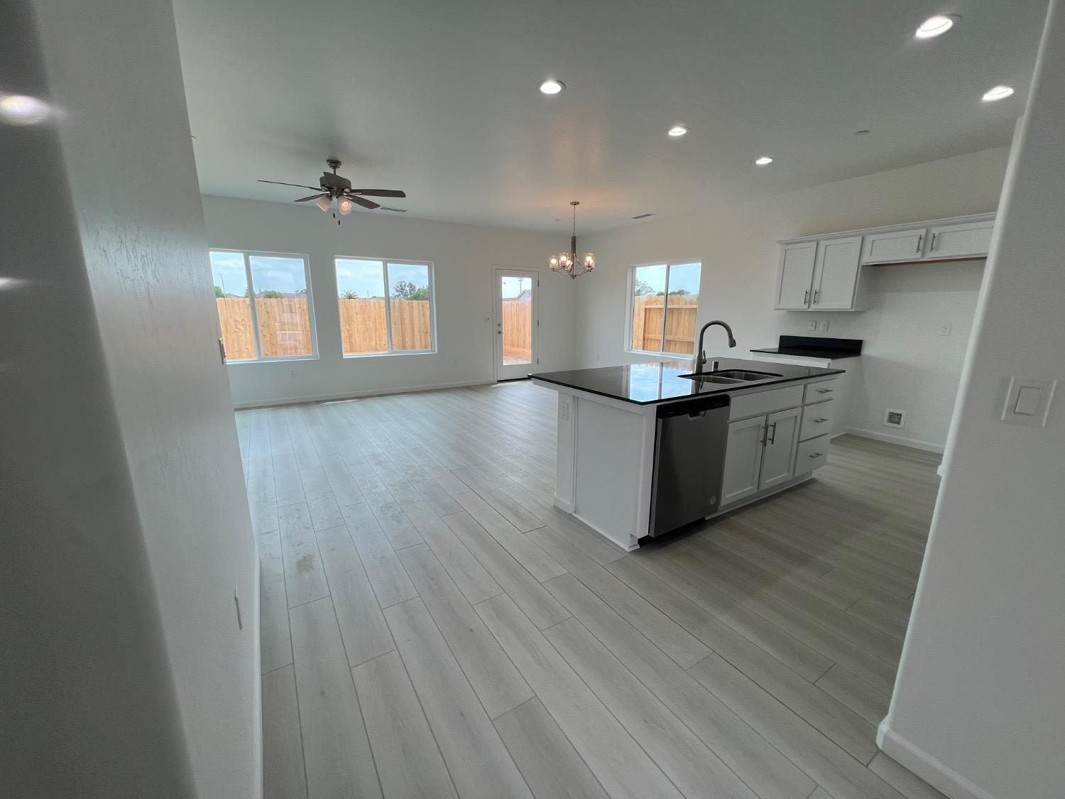 1502 Concord Way Dinuba, CA 93618 - Photo 5 of 12 a kitchen with stainless steel appliances granite countertop a stove and cabinets