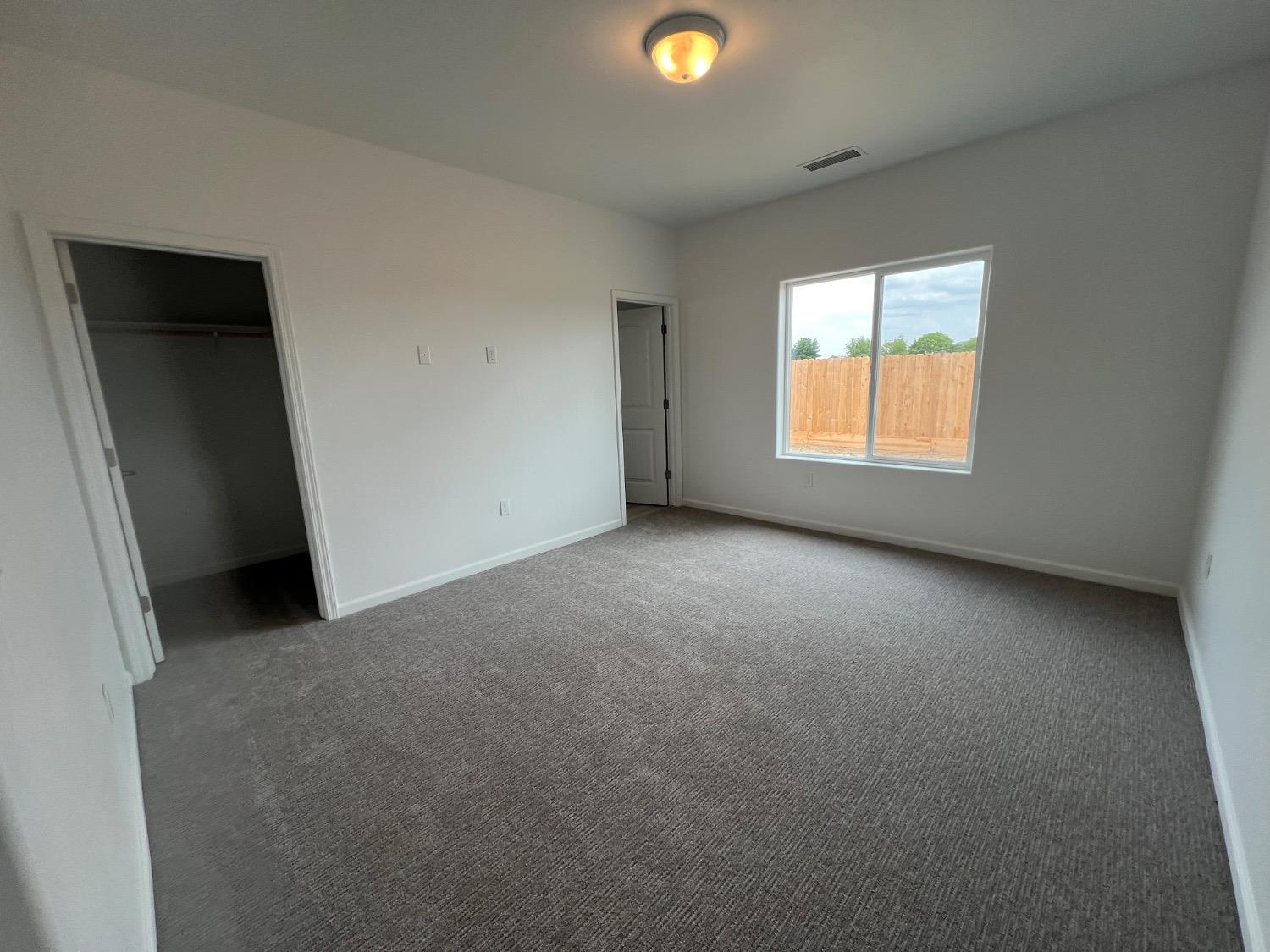 1502 Concord Way Dinuba, CA 93618 - Photo 10 of 12 an empty room with a window