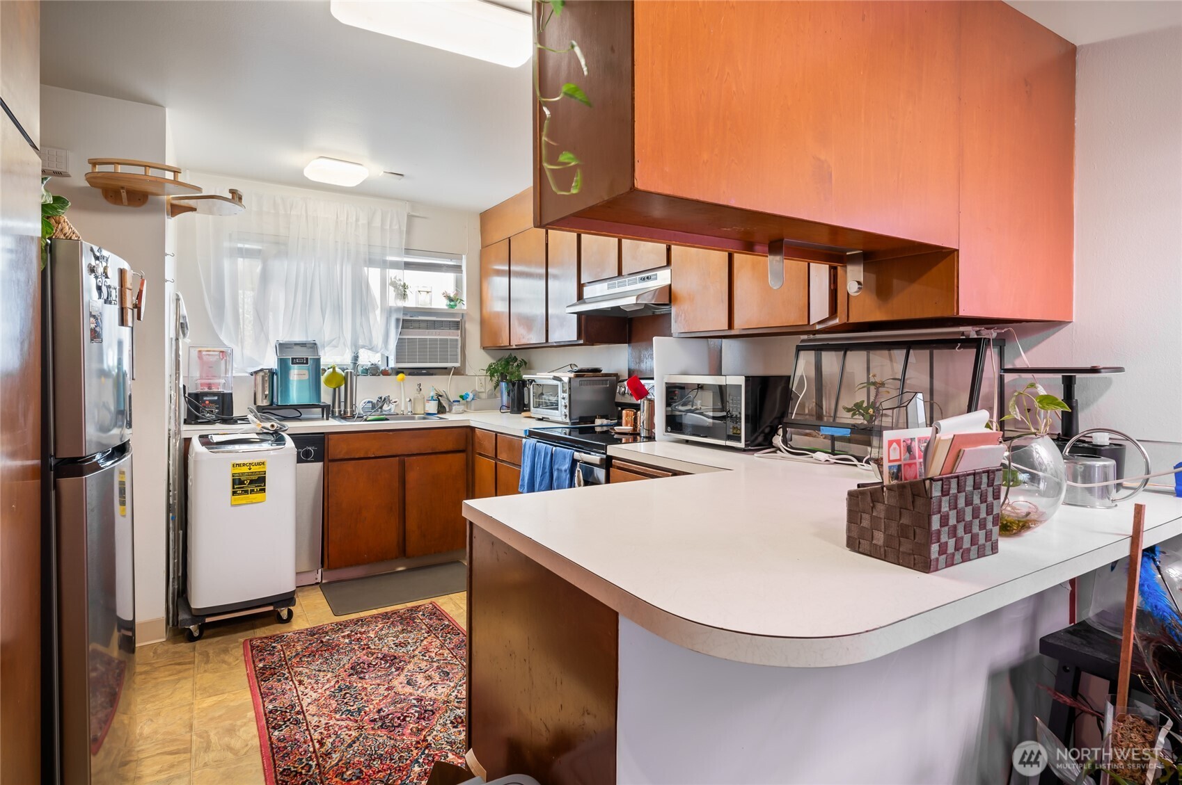 1017 Southwest 154th Street Burien, WA 98166 - Photo 10 of 17 a kitchen with sink a refrigerator and chairs