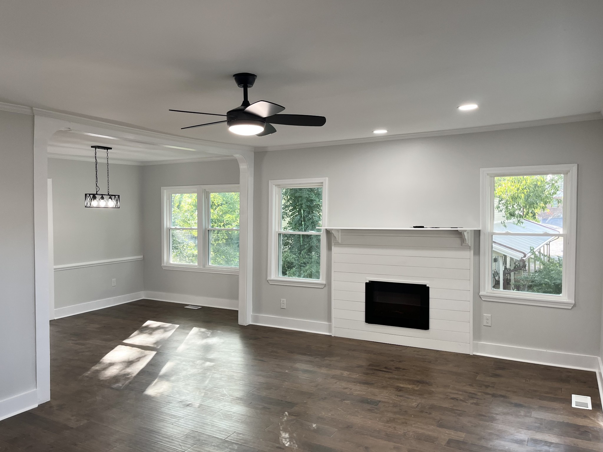 733 East Spring Street Cookeville, TN 38501 - Photo 4 of 23 an empty room with windows fireplace and wooden floor