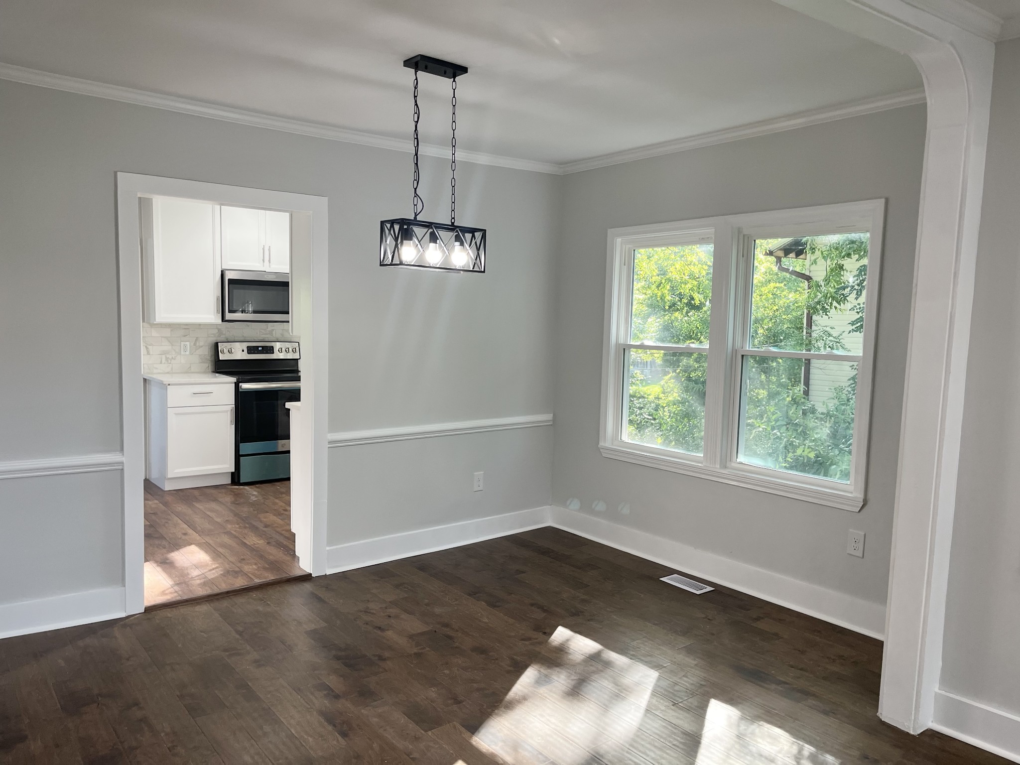 733 East Spring Street Cookeville, TN 38501 - Photo 6 of 23 a view of a livingroom with wooden floor kitchen view and a window