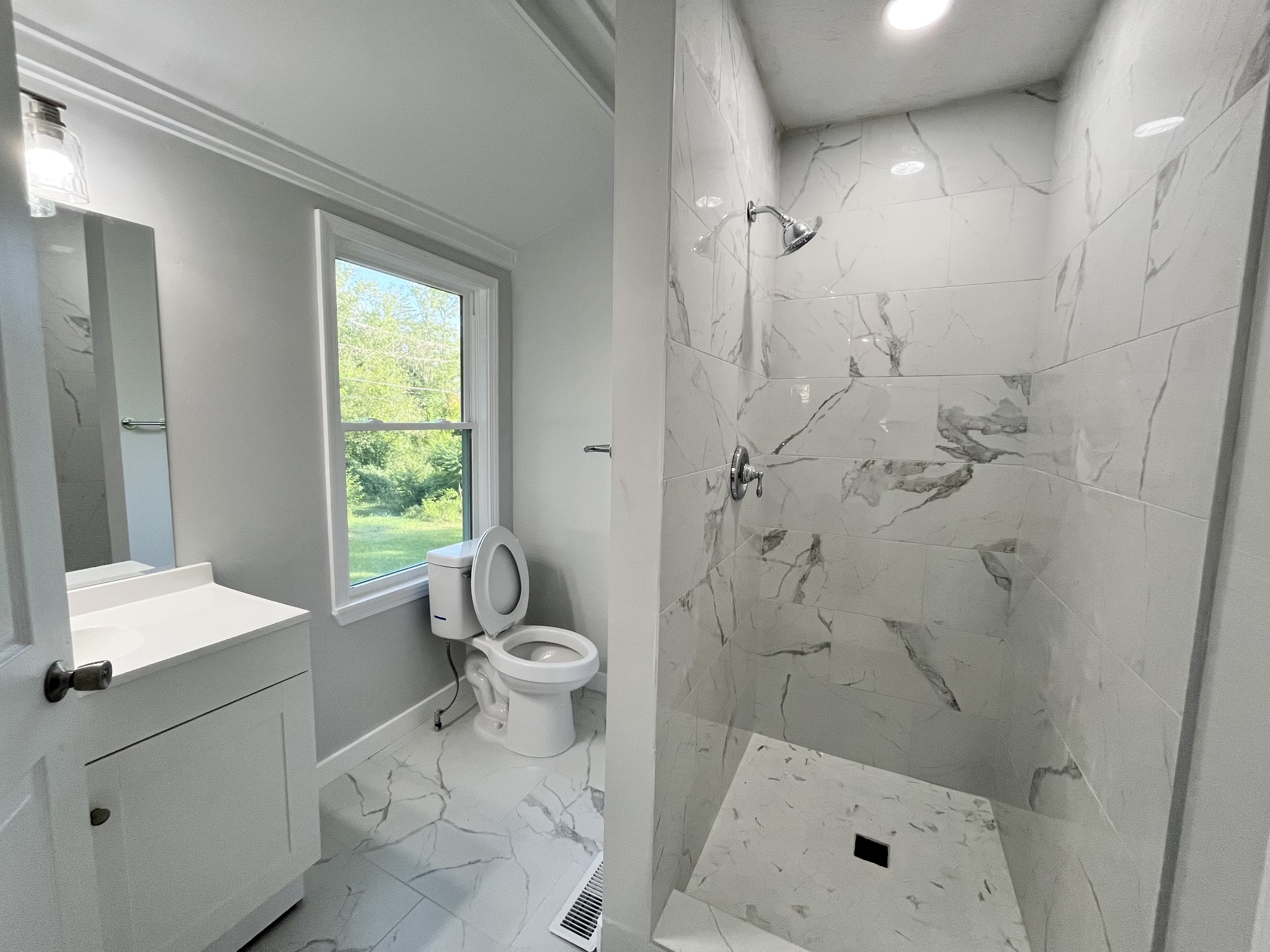 733 East Spring Street Cookeville, TN 38501 - Photo 9 of 23 a bathroom with a granite countertop sink a toilet and shower