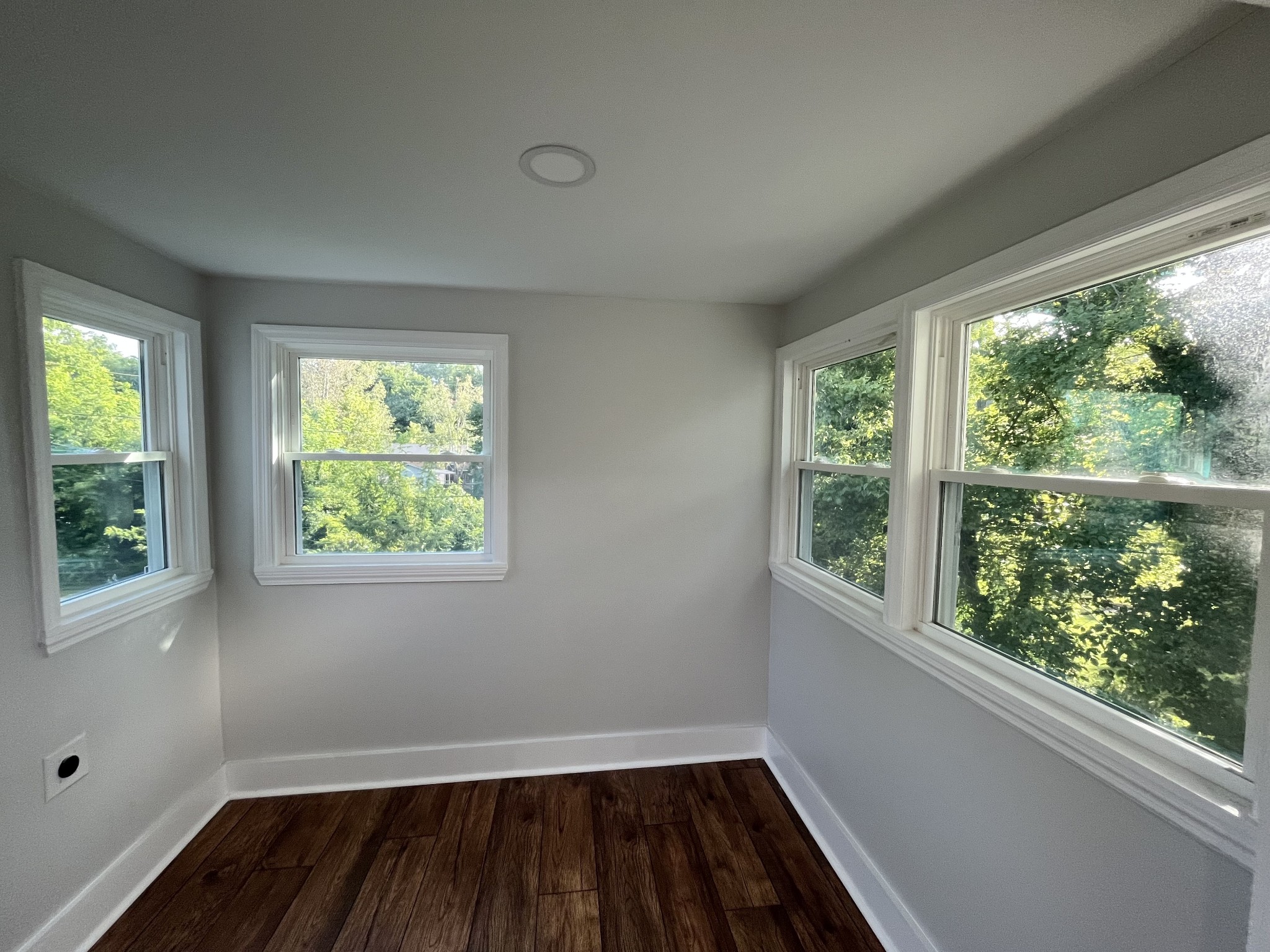 733 East Spring Street Cookeville, TN 38501 - Photo 10 of 23 an empty room with wooden floor and windows