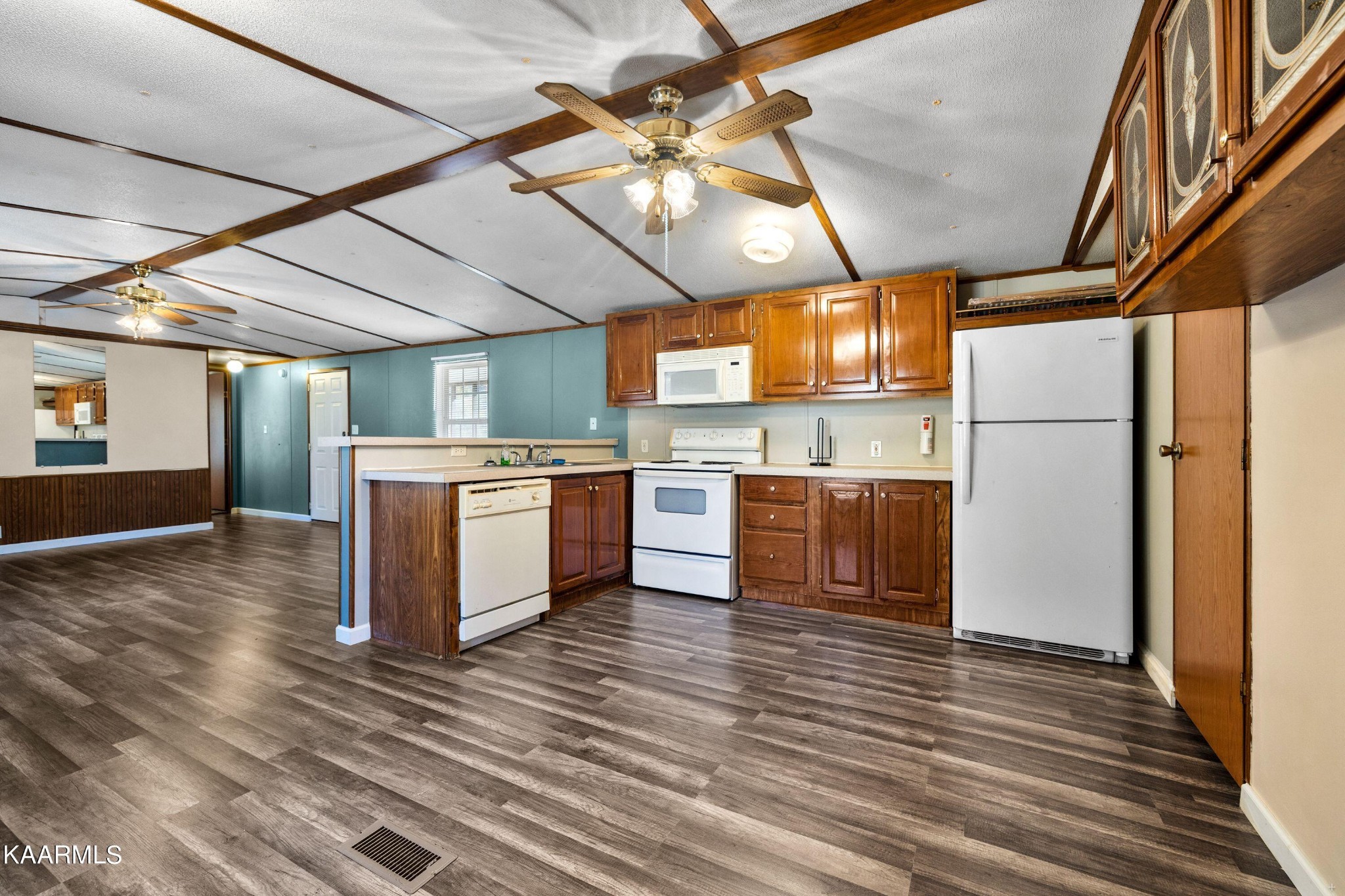 3220 West Wolf Valley Road Clinton, TN 37716 - Photo 5 of 15 a kitchen with a stove a refrigerator and a fireplace