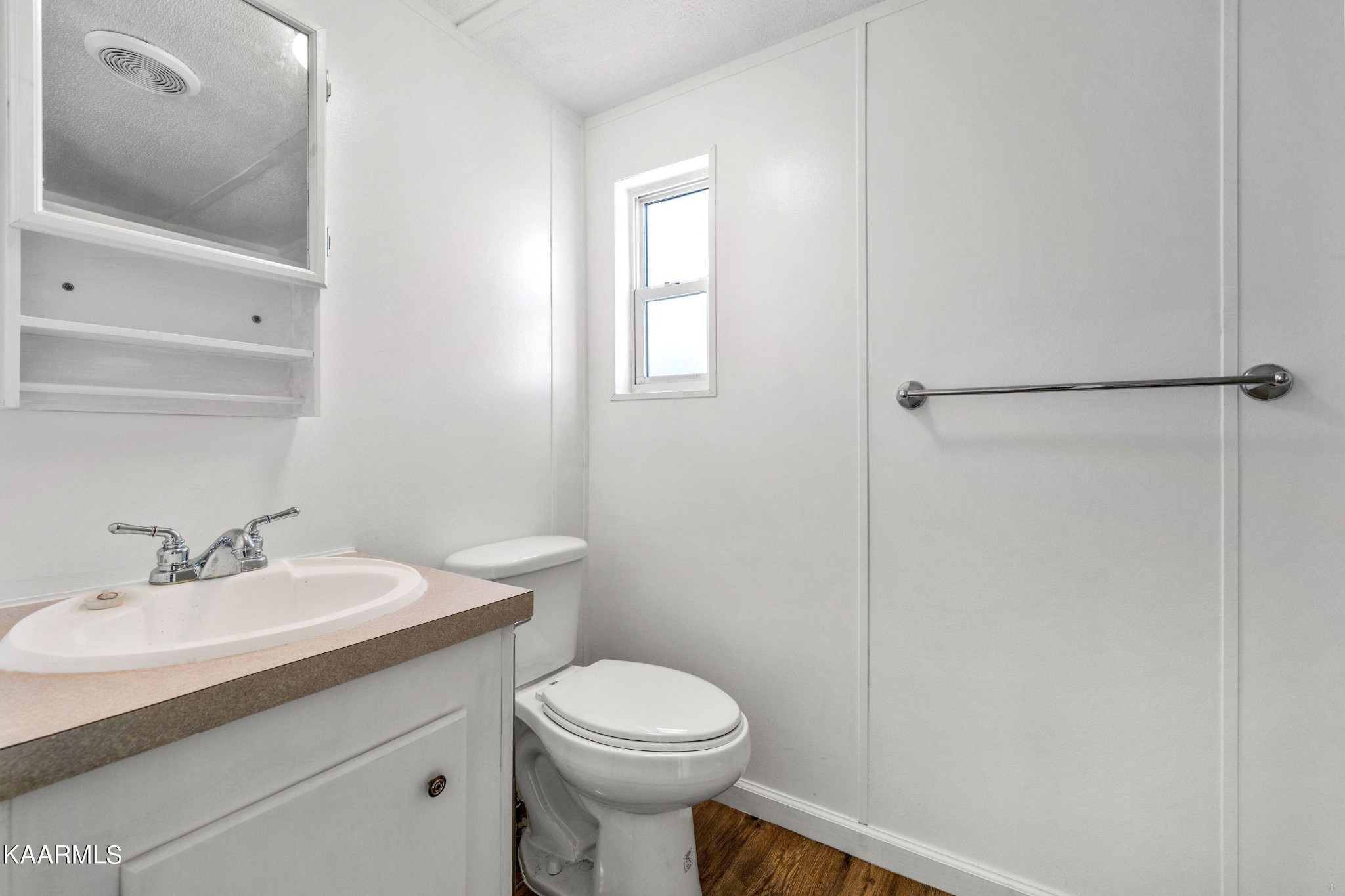 3220 West Wolf Valley Road Clinton, TN 37716 - Photo 8 of 15 a bathroom with a sink toilet and vanity