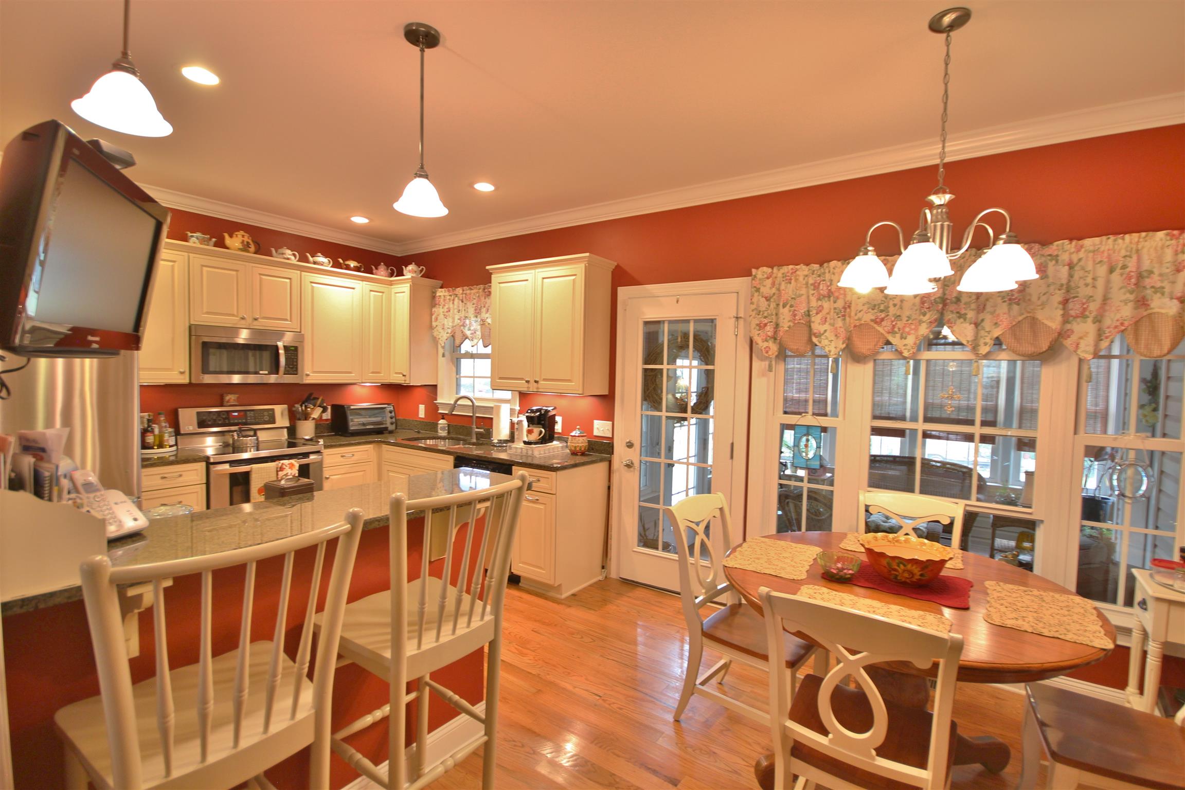 7508 King Road Fairview, TN 37062 - Photo 9 of 30 a view of a dining room and livingroom with furniture wooden floor a chandelier