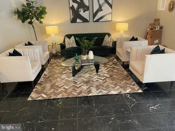 a living room with furniture and a rug