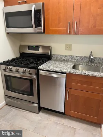 a stove top oven sitting inside of a kitchen