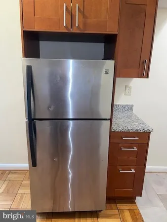 a view of a refrigerator in a kitchen