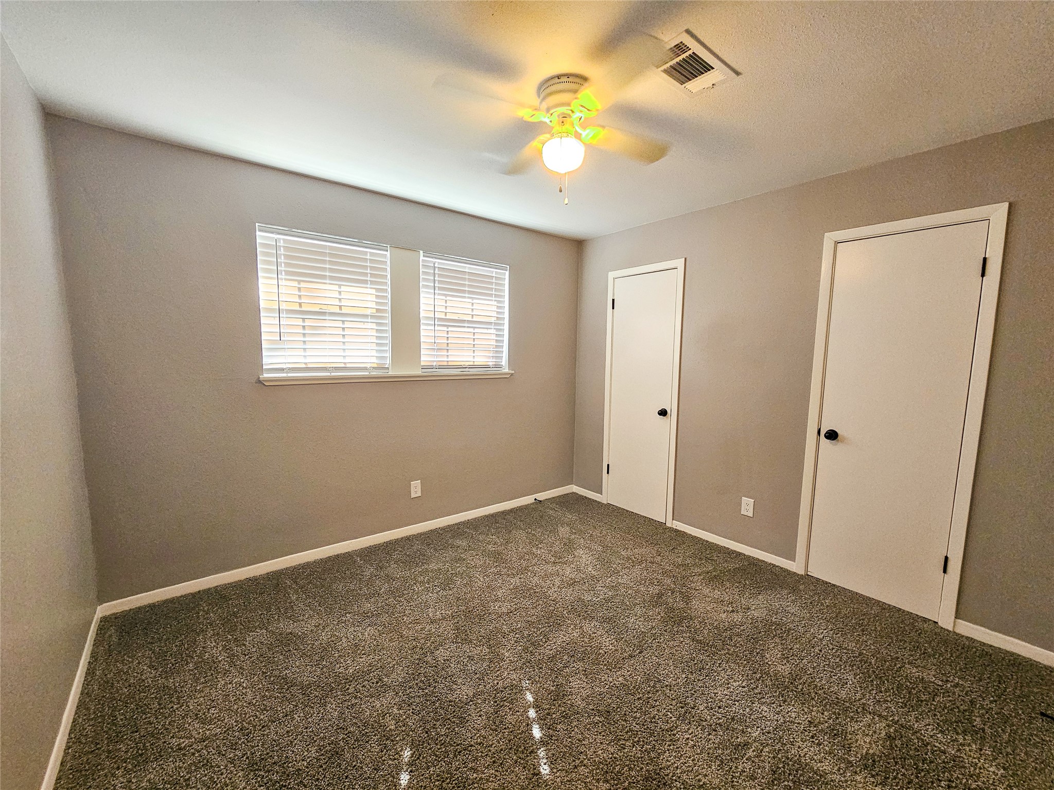 108 Oriole Lane Angleton, TX 77515 - Photo 17 of 20 an empty room with a window and a ceiling fan