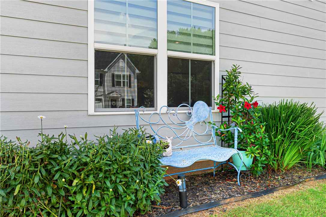 261 Scenic Road Anderson, SC 29621 - Photo 27 of 35 Lush landscaping beds line the exterior siding beneath large double windows.