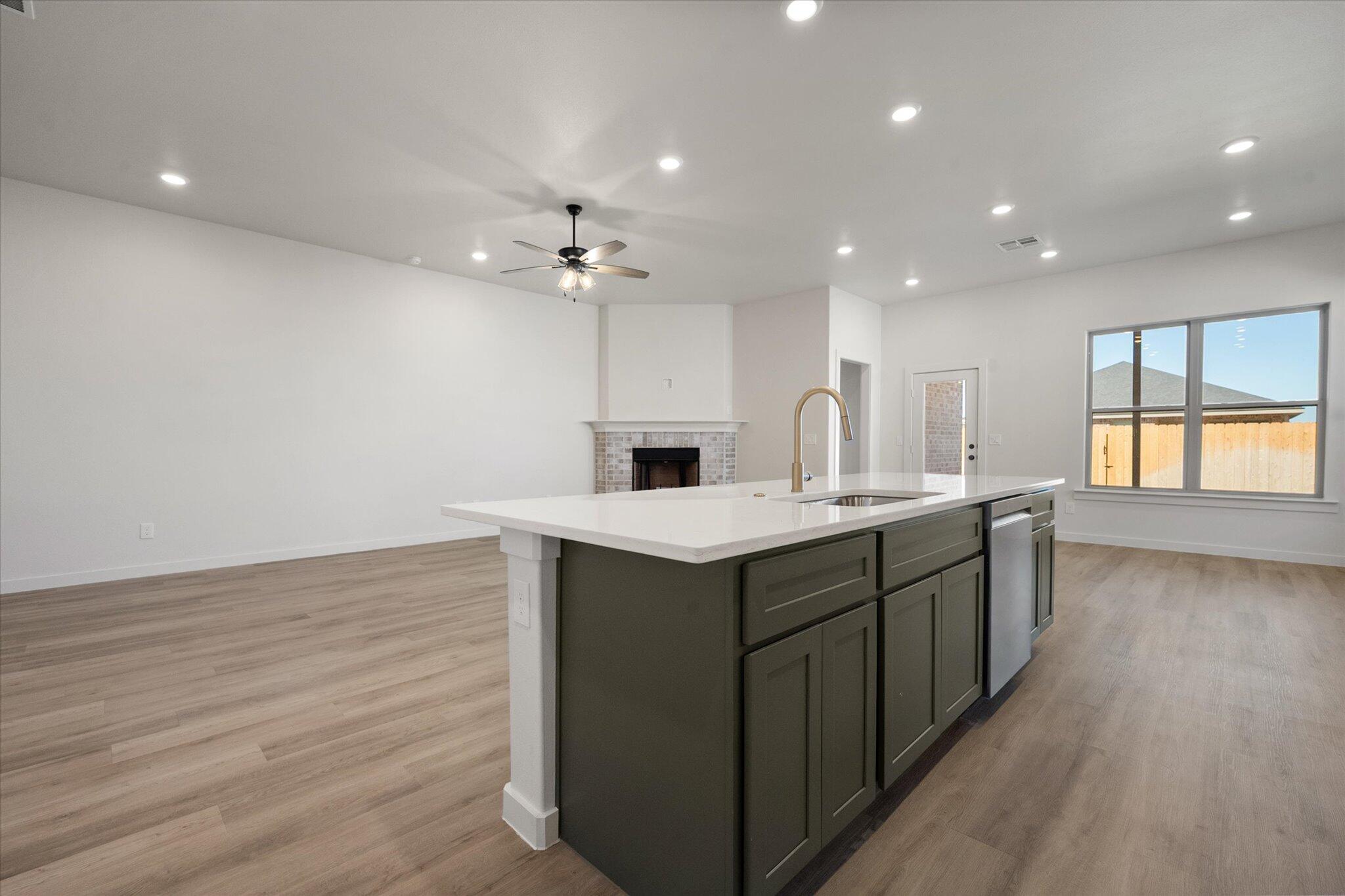 7004 16th Street Lubbock, TX 79416 - Photo 11 of 25 a kitchen with a sink and chandelier