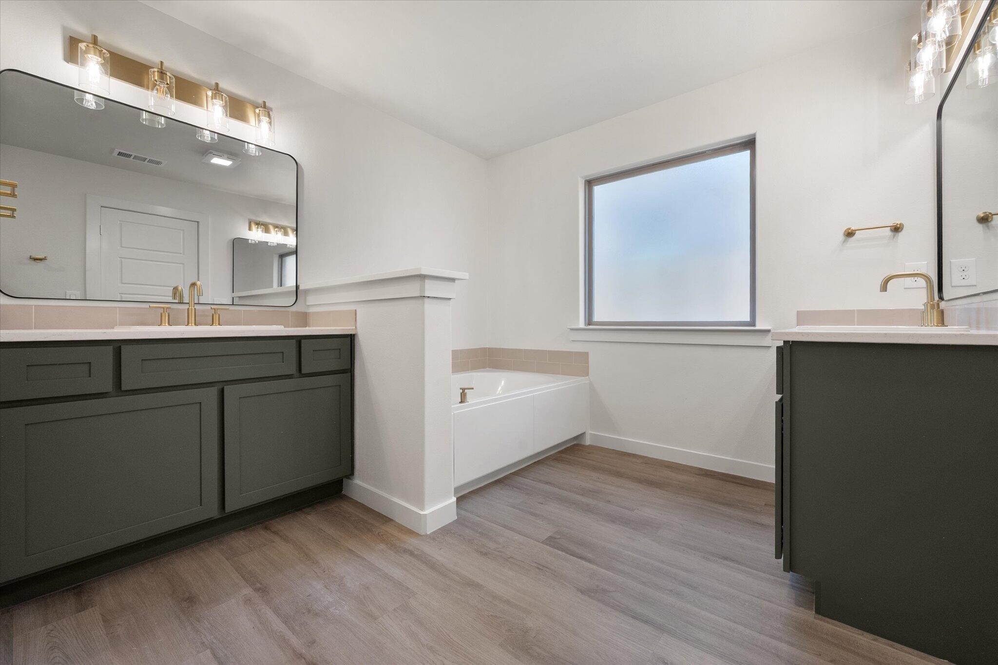 7004 16th Street Lubbock, TX 79416 - Photo 15 of 25 a kitchen with a sink cabinets and wooden floor