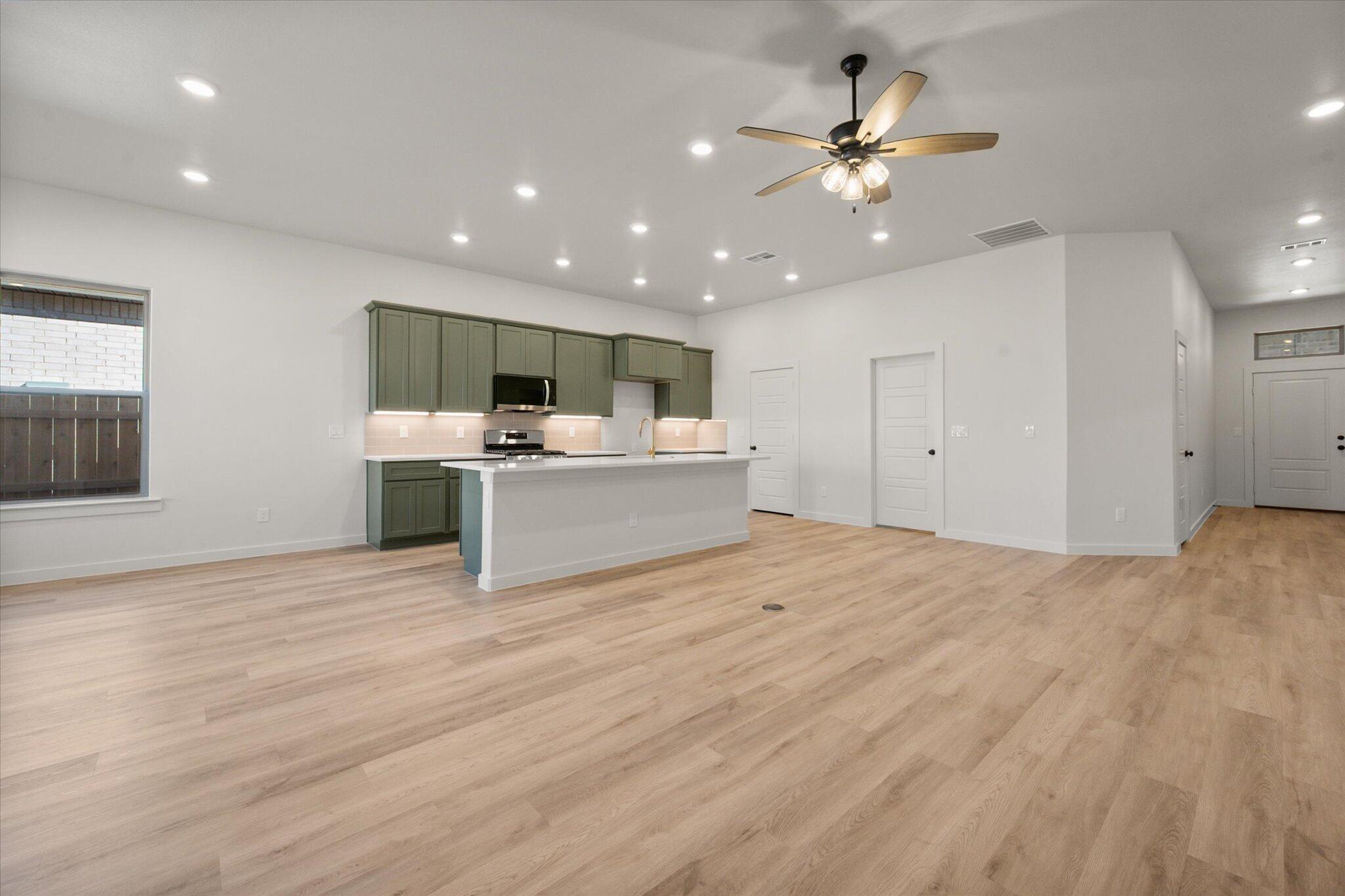 7004 16th Street Lubbock, TX 79416 - Photo 6 of 25 a view of kitchen with microwave and white cabinets