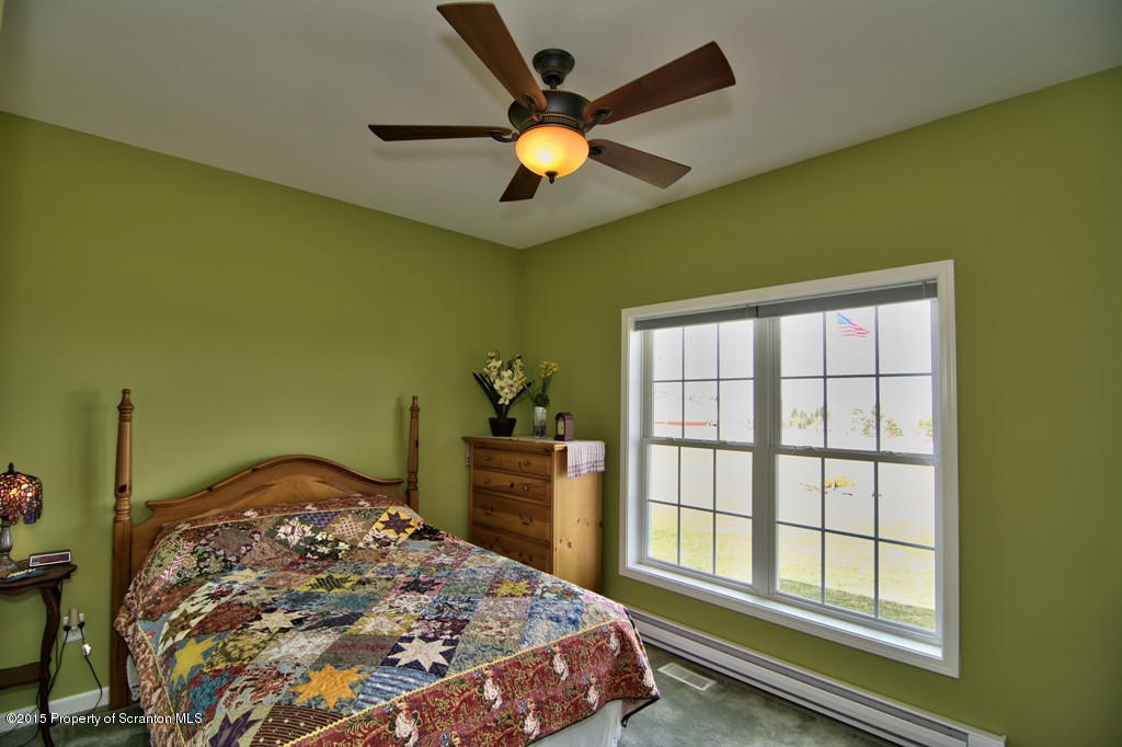1081 Motichka Road Moscow, PA 18444 - Photo 13 of 90 a bedroom with a bed and a large window