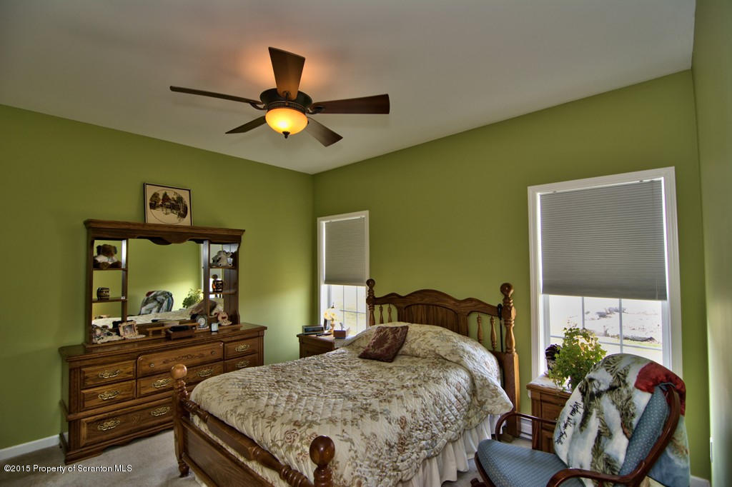 1081 Motichka Road Moscow, PA 18444 - Photo 15 of 90 a bedroom with a bed and a chandelier