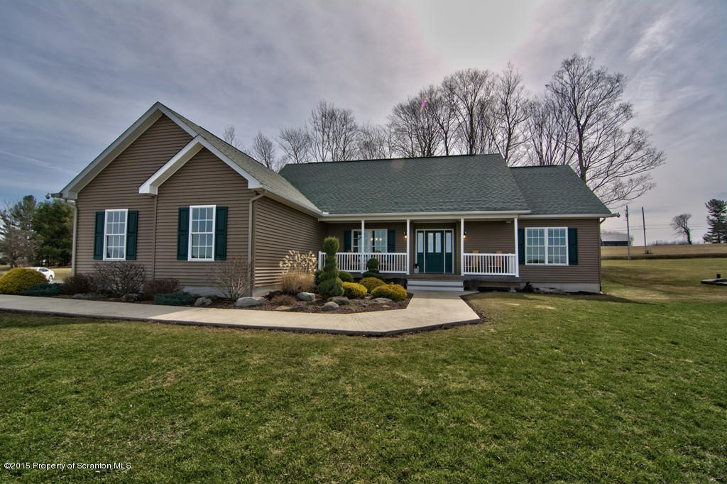 1081 Motichka Road Moscow, PA 18444 - Photo 20 of 90 a front view of a house with swing and garden
