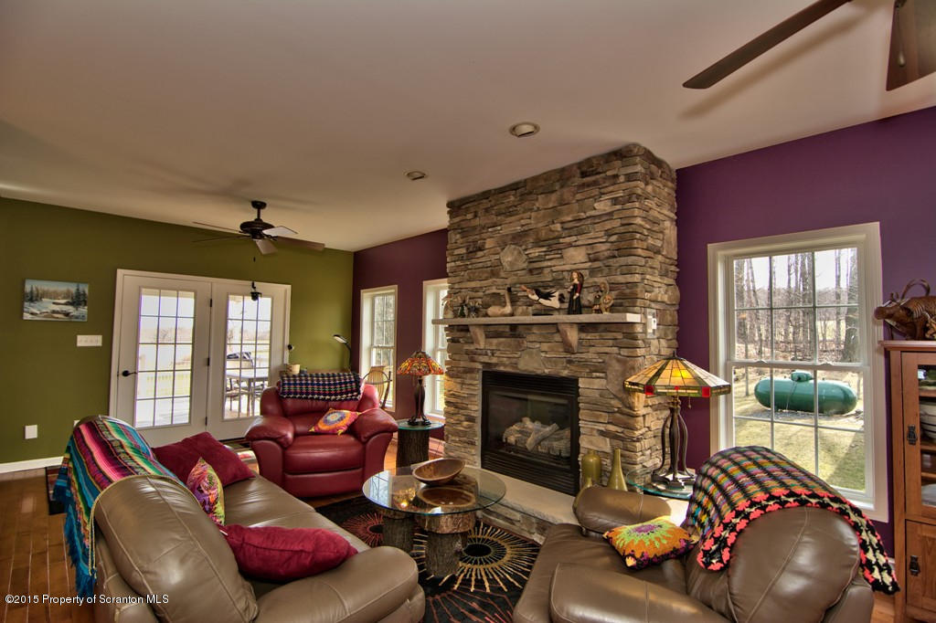 1081 Motichka Road Moscow, PA 18444 - Photo 49 of 90 a living room with furniture and a fireplace