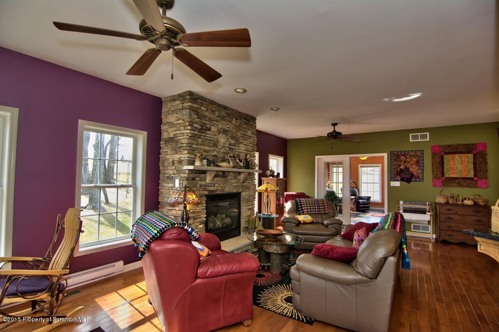 1081 Motichka Road Moscow, PA 18444 - Photo 50 of 90 a living room with furniture a fireplace and a flat screen tv