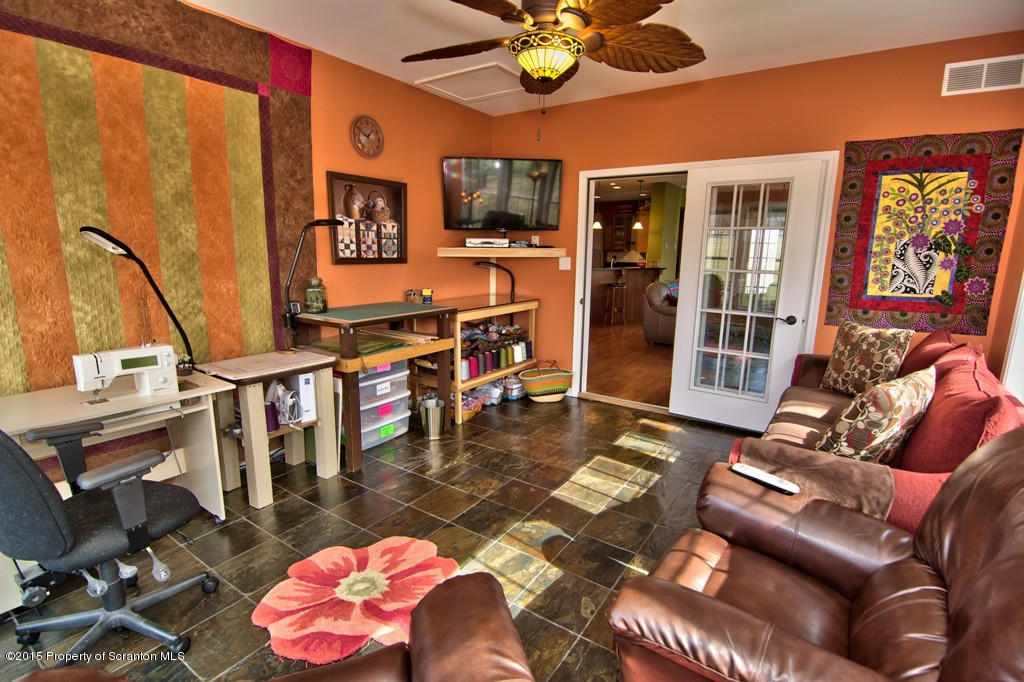 1081 Motichka Road Moscow, PA 18444 - Photo 57 of 90 a living room with furniture a rug and a chandelier