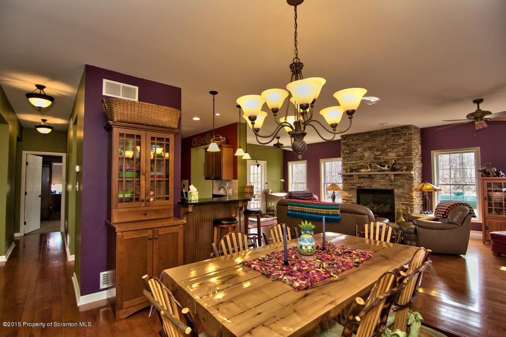 1081 Motichka Road Moscow, PA 18444 - Photo 7 of 90 a view of a dining room with furniture a chandelier and wooden floor