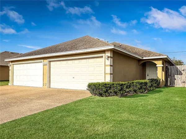 a front view of a house with garden