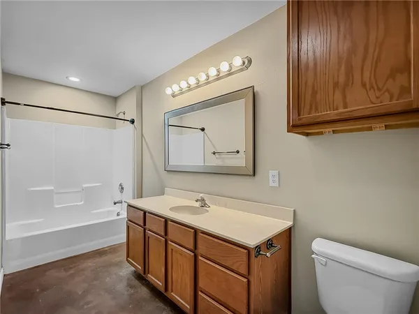 a bathroom with a sink a toilet and bathtub