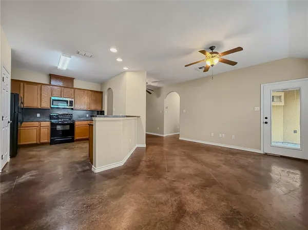 a view of a kitchen with furniture and a ceiling fan