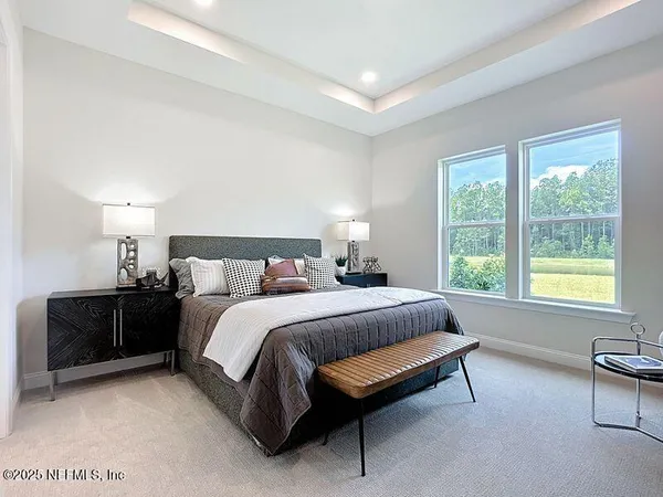a spacious bedroom with a bed and a couch