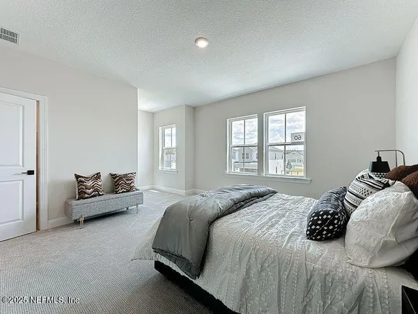a bedroom with a bed and couch