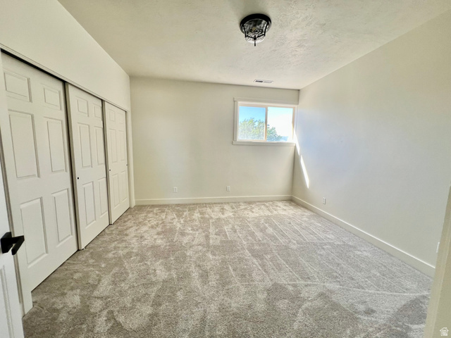 812 East Bates Cyn Road Tooele, UT 84074 - Photo 67 of 144 Neutral-toned carpeting paired with light walls and trim