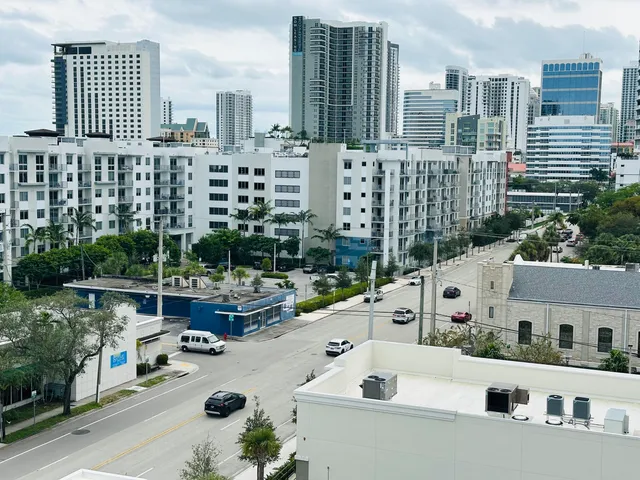 a kitchen with stainless steel appliances a refrigerator a stove and white cabinets
