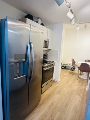 a bathroom with a toilet a sink a mirror and a rug