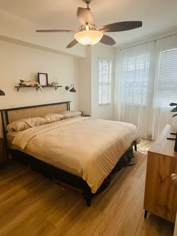 a bedroom with furniture and a flat screen tv