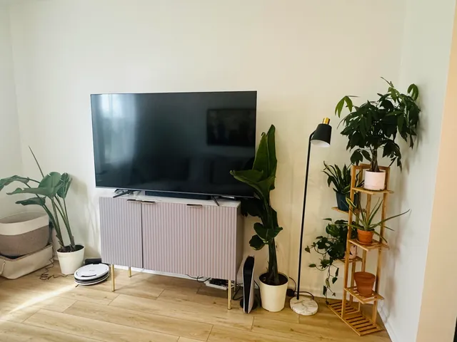 a kitchen with stainless steel appliances a dining table and chairs