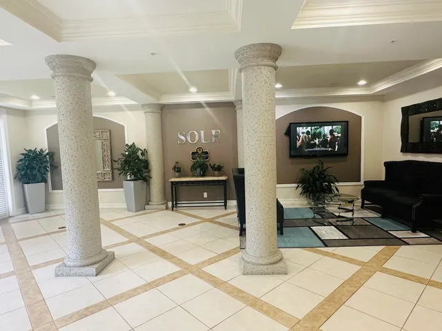 a view of a patio with a table and chairs under an umbrella
