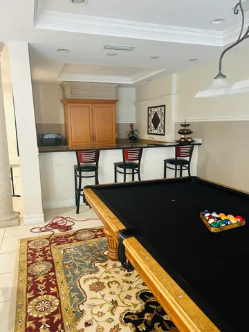 a view of a patio with table and chairs under an umbrella